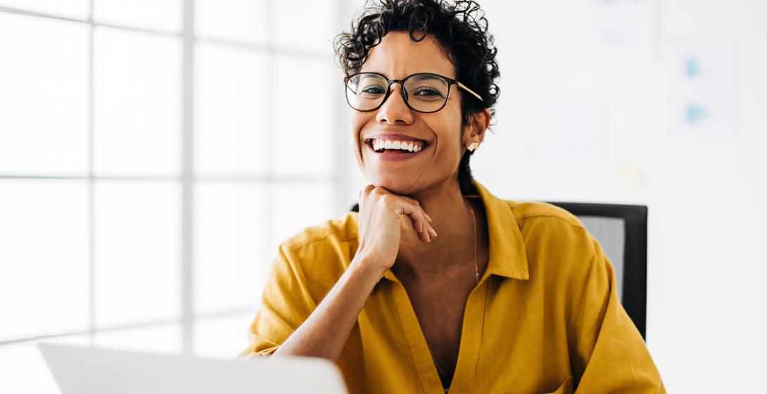 A medical science liaison sits at her desk with a laptop.
