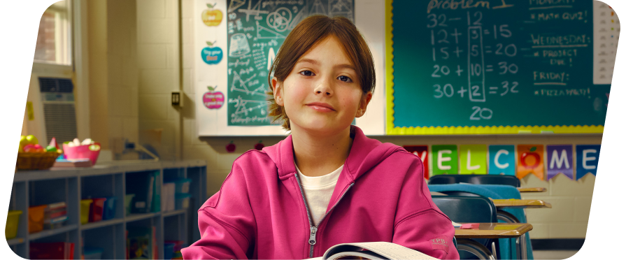 Kylie sits at her desk, happy that she's finished her homework.