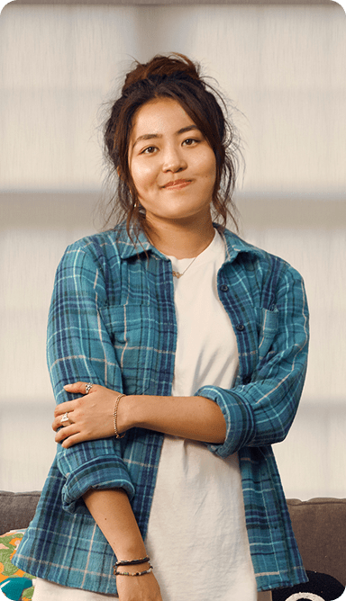 Emily, a 23-year-old woman with ADHD, in her apartment.